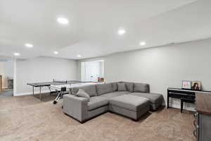 Living room featuring recessed lighting, visible vents, light colored carpet, and baseboards
