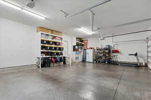 fully finished and painted third car garage with polished floors dual garage door openers and built-in shelving
