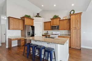 large island with room for 4 to 6 bar stools. custom cabinetry granite countertops pull out sprayer. this fridge is not included but there is an extra fridge in the garage that may be included.