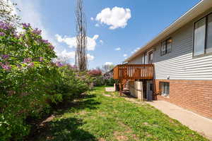 View of yard with stairway and a wooden deck