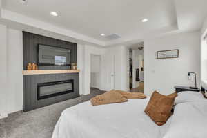 Bedroom featuring a tray ceiling, carpet, and recessed lighting