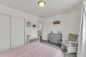 Carpeted bedroom with a closet