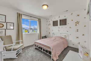 Bedroom featuring baseboards, visible vents, and carpet