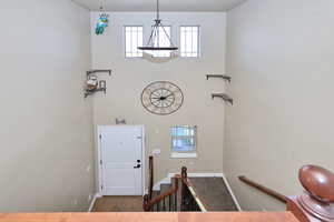 Entrance foyer featuring a towering ceiling, and stairs
