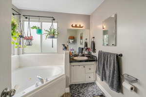 Bathroom with vanity and a whirlpool tub