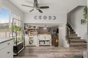 Interior space with stairs, ceiling fan, and wood finished floors