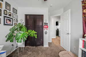 Carpeted entrance foyer featuring baseboards