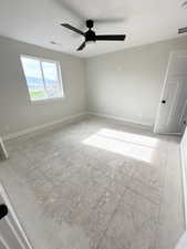 Spare room featuring ceiling fan and baseboards