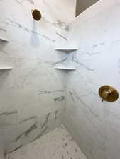 Bathroom with a marble finish shower