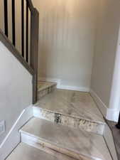 Staircase featuring baseboards