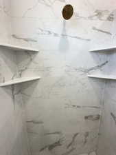 Bathroom with a marble finish shower