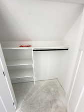 Walk in closet with vaulted ceiling