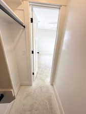 Hallway featuring baseboards