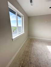 Spare room featuring visible vents and baseboards