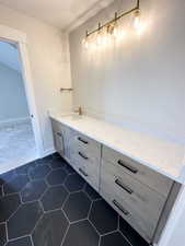 Bathroom featuring tile patterned flooring and vanity