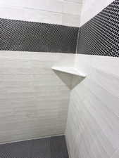 Room details with tiled shower