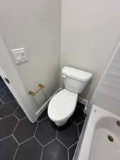 Bathroom featuring tile patterned floors and toilet
