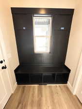 Mudroom featuring light wood-style flooring and baseboards
