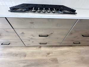 Details featuring gray cabinetry, light countertops, and stainless steel gas cooktop