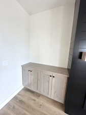 Interior space with baseboards and wood finished floors