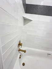 Room details featuring bathtub / shower combination