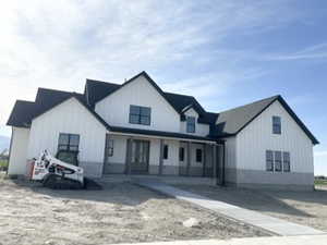 Modern inspired farmhouse with board and batten siding and a porch