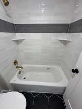 Bathroom with tile patterned floors and toilet