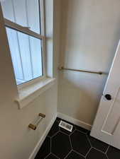 Bathroom featuring tile patterned floors, visible vents, and baseboards