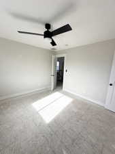Unfurnished bedroom with baseboards, a ceiling fan, and carpet
