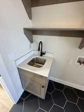 Laundry area featuring washer hookup, baseboards, laundry area, and a sink