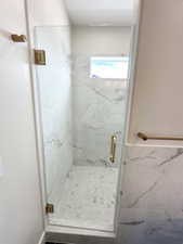 Full bathroom featuring a marble finish shower