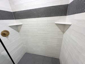 Room details featuring tiled shower
