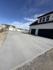 View of home's exterior with driveway and a garage