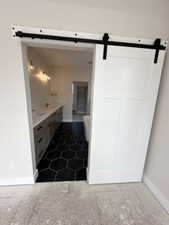 Bathroom with vanity and baseboards