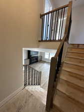 Stairway featuring hardwood / wood-style floors and baseboards