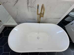 Room details featuring a freestanding tub and toilet