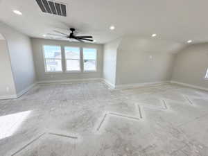Interior space featuring recessed lighting, visible vents, lofted ceiling, and baseboards