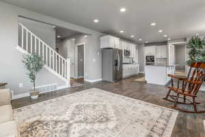 Kitchen with recessed lighting, visible vents, dark wood-style floors, and stainless steel appliances
