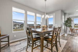 Dining space featuring a chandelier, wood-type flooring, baseboards, and recessed lighting