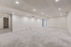 Finished basement with visible vents and recessed lighting