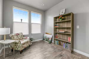 Living area with baseboards and wood finished floors