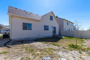 Back of house with roof with shingles, central AC, entry steps, and fence
