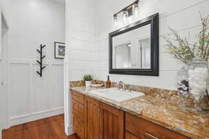 Bathroom featuring vanity and wood finished floors