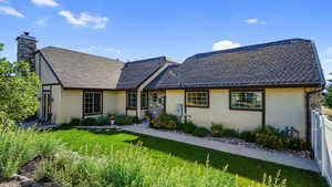 Tudor-style house featuring stucco siding and a chimney