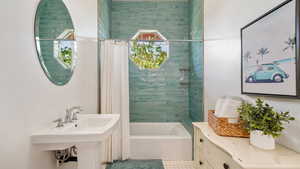 Bathroom featuring tile patterned floors and shower / bathtub combination with curtain