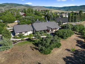Aerial view of property and surrounding area with a mountain backdrop