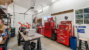 Garage with a workshop area and a garage door opener