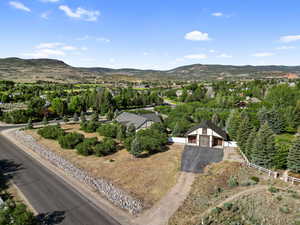 Aerial overview of property's location featuring a mountainous background