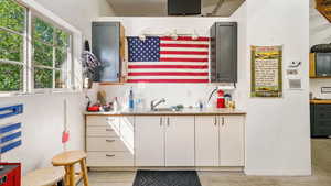 Kitchen with healthy amount of natural light, light countertops, and white cabinets