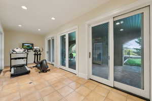 Exercise area featuring tile patterned floors and recessed lighting